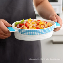 ceramic bakeware with heat-resistant silicone handle grips and non-slip silicone base
